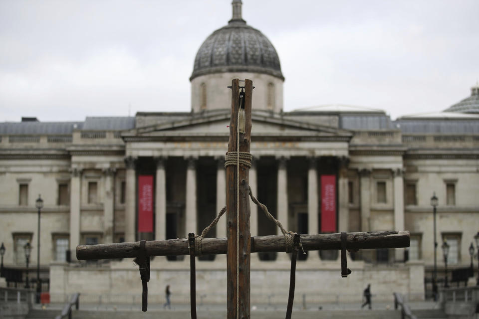 A crucifix placed in Trafalgar Square on Good Friday, the day Christians commemorate the crucifixion of Jesus and his death at Calvary, in London, Friday April 2, 2021. (Aaron Chown/PA via AP)