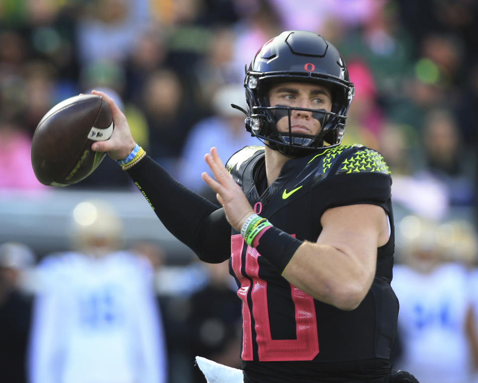 Oregon's Bo Nix throws down field against UCLA during the first half in an NCAA college football game Saturday, Oct. 22, 2022, in Eugene, Ore. (AP Photo/Chris Pietsch)
