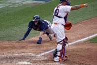 Atlanta Braves' Dansby Swanson, left, scores a run behind New York Mets catcher Wilson Ramos during the 10th inning of a baseball game Saturday, July 25, 2020, in New York. (AP Photo/Adam Hunger)