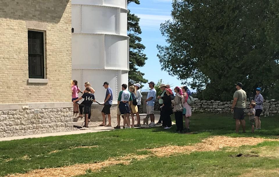Visitors line up to enter the 89-foot-tall light tower and climb its 97 steps to get to the top of the Cana Island Lighthouse in Baileys Harbor. The Door County Maritime Museum opened the tower and light keeper's house to the public for the first time this season on Aug. 12 after a preservation and restoration project.