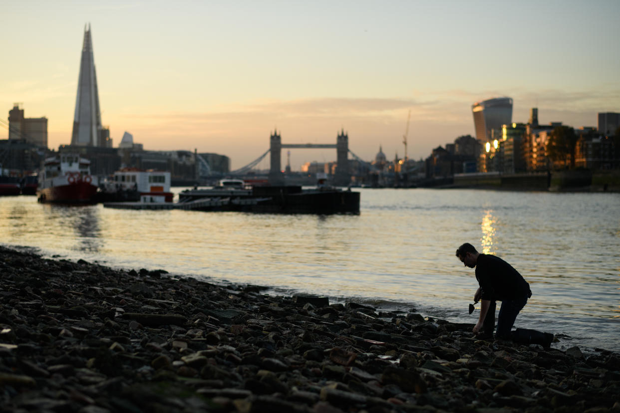 LONDON, ENGLAND - OCTOBER 20: Tower Bridge is seen in the distance as Mudlark Jason Sandy searches the shoreline of the River Thames for historical items on October 20, 2018 in London, England. Moving to London eleven years ago, US-born Jason Sandy fell in love with the history that was available to explore on his doorstep and now has over 35,000 followers on his instagram feed 