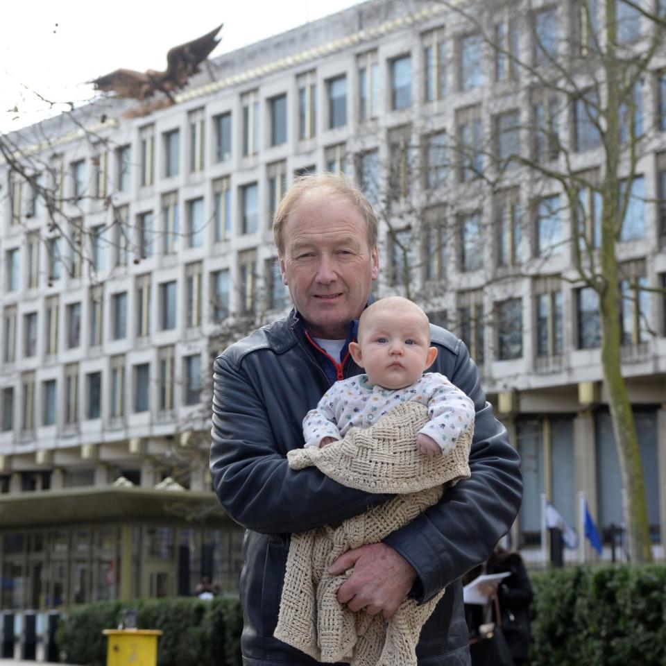 Paul Kenyon with his three-month-old grandson Harvey Kenyon-Cairns outside the US embassy - Credit: Steve Finn Photography