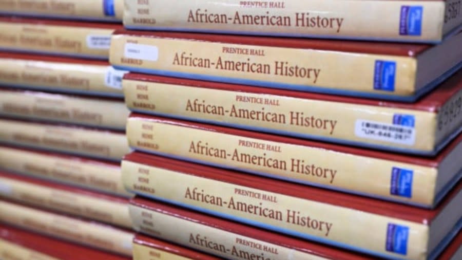 Books sit piled up in the classroom for students who took AP African-American studies in November at Overland High School in Aurora, Colorado. Florida rejected such a course because leaders objected to topics such as reparations, the Black Lives Matter movement and “queer theory.” (Photo: RJ Sangosti/MediaNews Group/The Denver Post via Getty Images)