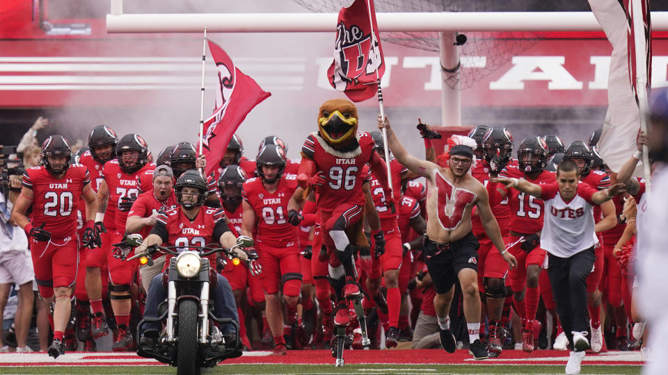 Utah players take the field for an NCAA college football game against Weber State on Thursday, Sept. 2, 2021, in Salt Lake City. (AP Photo/Rick Bowmer)