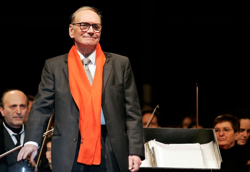 FILE PHOTO: Italian movie composer Morricone conducts the Sinfonietta orchestra during a Christmas concert in Milan