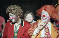 <p>Kevin Thompson, celebrating his fourth year in Ringling Bros. Barnum and Bailey’s famed Clown Alley, watches as 9-year-old Jonathon Young tries his hand at clowning during a visit by the circus troupe to Temple Beth Solomon of the Deaf in Arleta, California, Sept. 14, 1984. (AP Photo/Liu Heung Shing) </p>