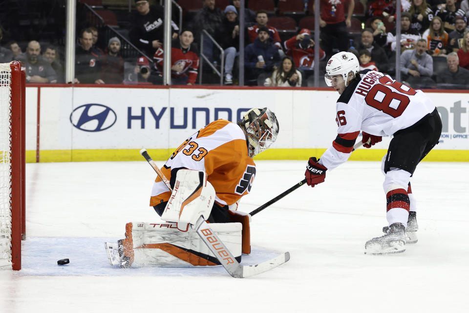 New Jersey Devils center Jack Hughes (86) scores a goal past Philadelphia Flyers goaltender Samuel Ersson during the second period of an NHL hockey game Saturday, Feb. 25, 2023, in Newark, N.J. (AP Photo/Adam Hunger)