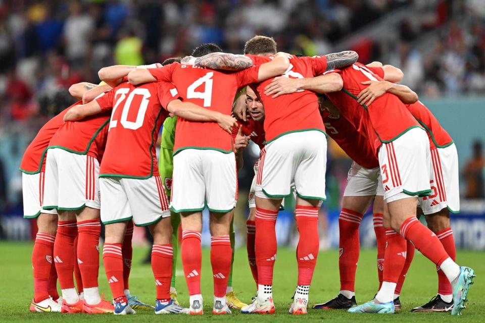 Wales players gather in a huddle as Gareth Bales gives a team talk ahead of the match (AFP/Getty)