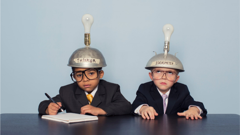 Two children wearing "thinking hats"