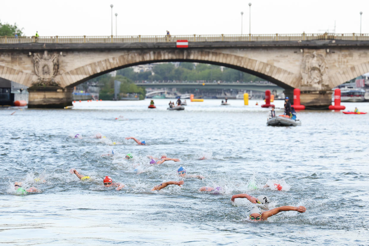 Olympians swim in the Seine river.