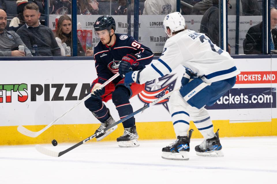 Dec 29, 2023; Columbus, Ohio, USA;
Columbus Blue Jackets center Jack Roslovic (96) attempts to shoot the puck against Toronto Maple Leafs defenseman Simon Benoit (2) during the third period of their game on Friday, Dec. 29, 2023 at Nationwide Arena.