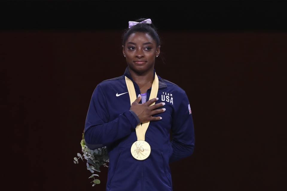 Gold medalist Simone Biles of the United States listens to the national anthem during the award ceremony for the floor exercise in the women's apparatus finals at the Gymnastics World Championships in Stuttgart, Germany, Sunday, Oct. 13, 2019. (AP Photo/Matthias Schrader)