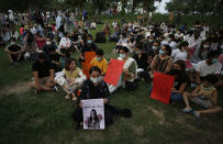 Women's rights activists attend a candle light vigil to pay tribute to Noor Mukadam, who was recently beheaded, and other domestic violence victims in Islamabad, Pakistan, Sunday, July 25, 2021. The killing of Kukadam in an upscale neighborhood of Pakistan's capital has shone a spotlight on the relentless violence against women in the country. Rights activists say such gender-based assaults are on the rise as Pakistan barrels toward greater religious extremism. (AP Photo/Anjum Naveed)