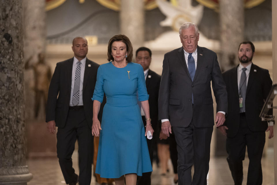 FILE - In this March 13, 2020, file photo Speaker of the House Nancy Pelosi, D-Calif., and Majority Leader Steny Hoyer, D-Md., arrive to make a statement ahead of a planned late-night vote on the coronavirus aid package deal, at the Capitol in Washington. Democrats are wrestling over how best to assail Trump for his handling of the coronavirus pandemic and the economy’s shutdown even as the country enters an unpredictable campaign season against the backdrop of the most devastating crisis in decades. (AP Photo/J. Scott Applewhite, File)