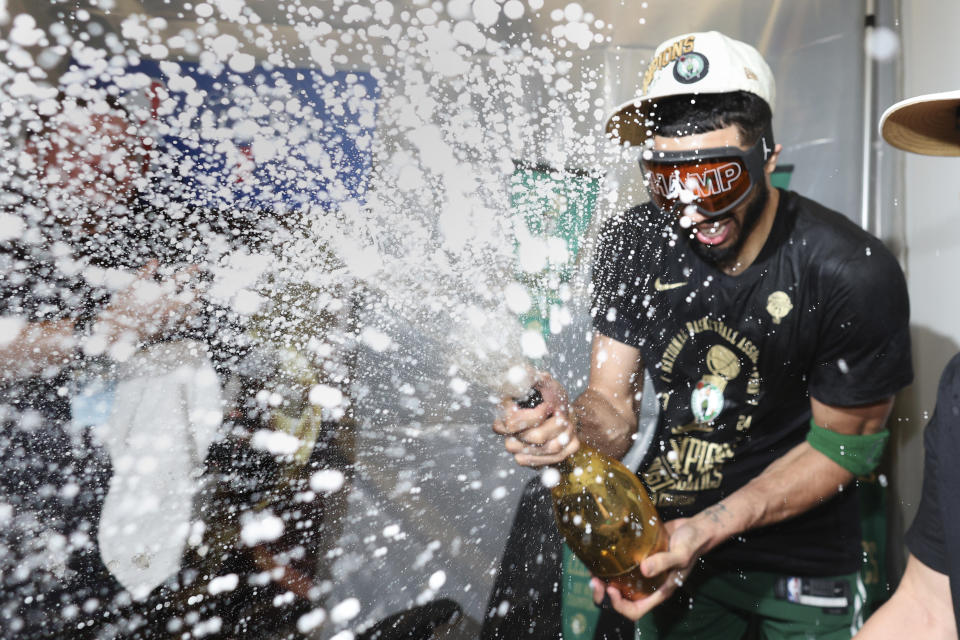 Boston Celtics forward Jayson Tatum sprays champagne while celebrating after defeating the Dallas Mavericks in Game 5 to win the NBA basketball finals Monday, June 17, 2024, in Boston. (Elsa/Pool Photo via AP)