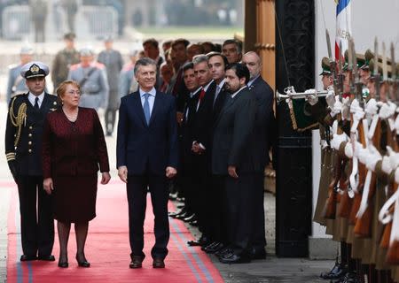 Argentina's president Mauricio Macri and Chile's president Michelle Bachelet review honour guards at the La Moneda Presidential palace during Macri's official visit in Santiago, Chile June 27, 2017. REUTERS/Rodrigo Garrido