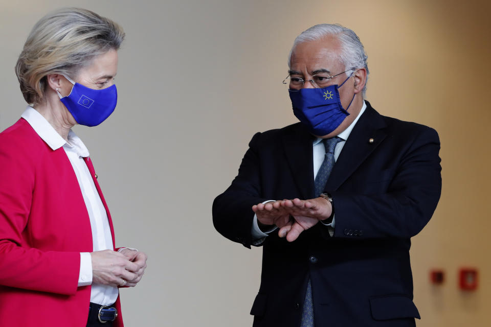 Portuguese Prime Minister Antonio Costa, right, and European Commission President Ursula Von Der Leyen chat after posing for a group photo with Portuguese cabinet ministers and EU commissioners at the Belem Cultural Center in Lisbon, Friday, Jan. 15, 2021. The Portuguese presidency of the EU is receiving the College of Commissioners of the European Commission for a round of meetings. (AP Photo/Armando Franca)