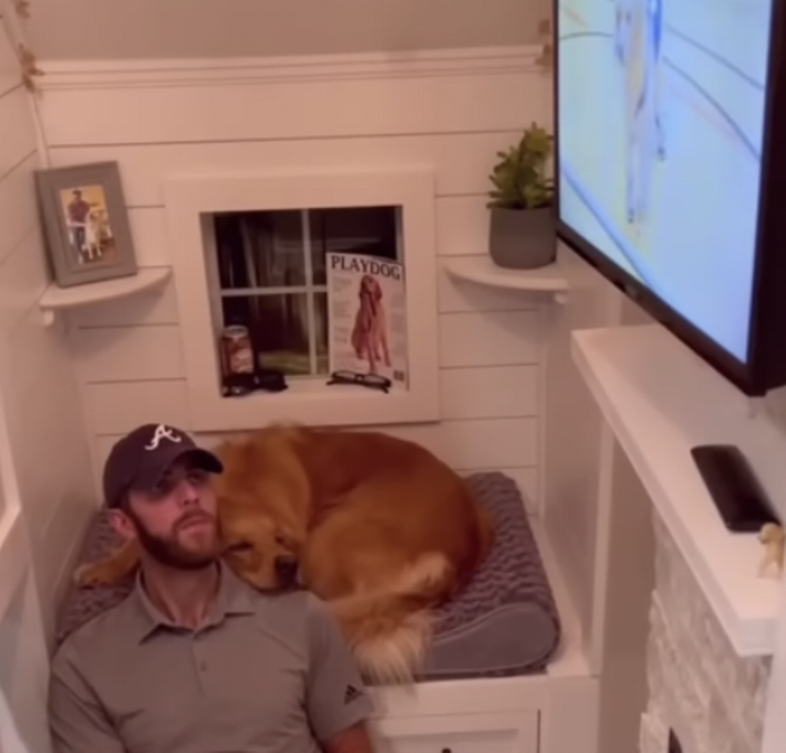 Johnathan Lower and his dog Teddy enjoy movie night in Teddy’s luxury dog house.