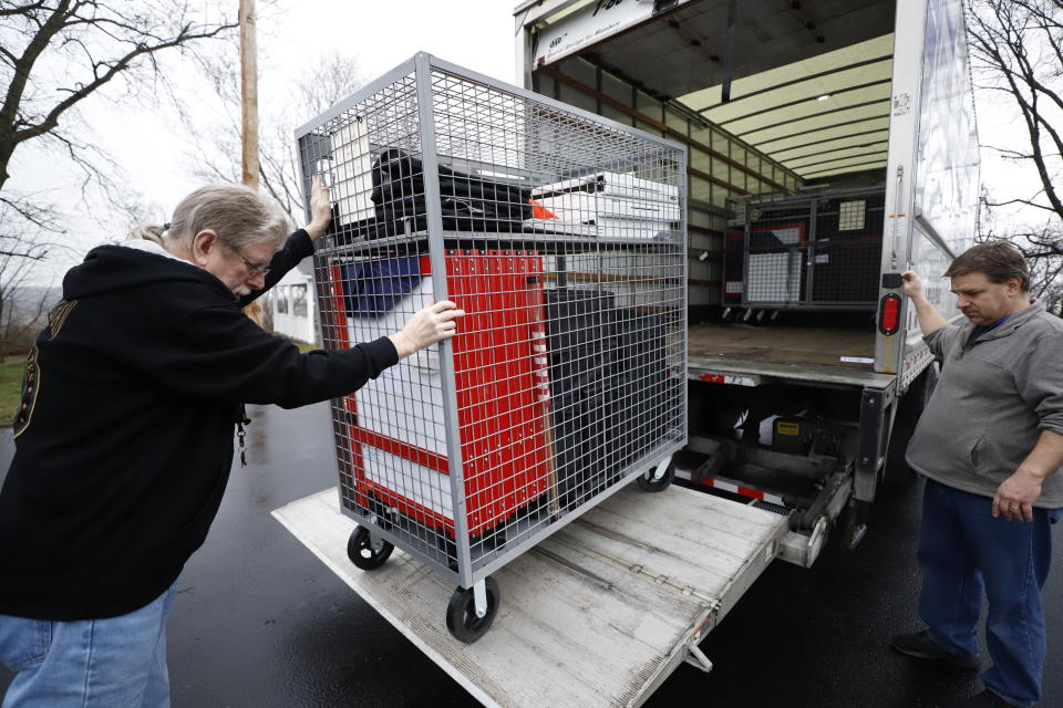 Voting machines are collected from a polling place at Our Lady of Lourdes church in Wintersville, Ohio, Tuesday, March 17, 2020. Ohio's presidential primary was postponed Tuesday amid coronavirus concerns. (AP Photo/Gene J. Puskar)