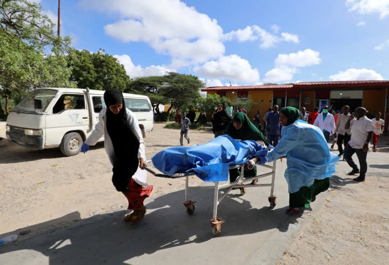 Paramedics and civilians at Madina hospital assist an injured man after a minibus struck a roadside bomb at Hawa Abdi village, northwest of Mogadishu