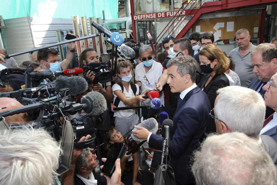 French Interior Minister Gerald Darmanin answers to media during a visit in Bayonne, southwestern France, Saturday, July 11, 2020. The wife of a French bus driver savagely beaten after he asked four of his passengers to wear face masks aboard his vehicle called Saturday for "exemplary punishment" after he died of his injuries. (AP Photo/Bob Edme)