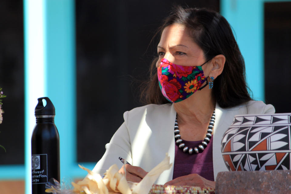 FILE - In this April 6, 2021, file photo, U.S. Interior Secretary Deb Haaland listens to tribal leaders and jots down notes during a round-table discussion at the Indian Pueblo Cultural Center in Albuquerque, N.M. Secretary Haaland will visit Utah this week before submitting a review on national monuments in the state. She's expected to submit a report to President Joe Biden after she meets with tribes and elected leaders at Bears Ears National Monument on Thursday, April 8, 2021. (AP Photo/Susan Montoya Bryan, File)