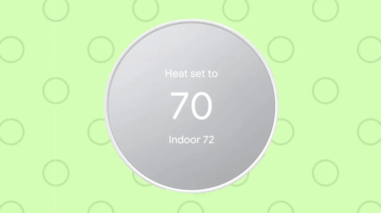 A Google Nest thermostat with LCD screen reading 