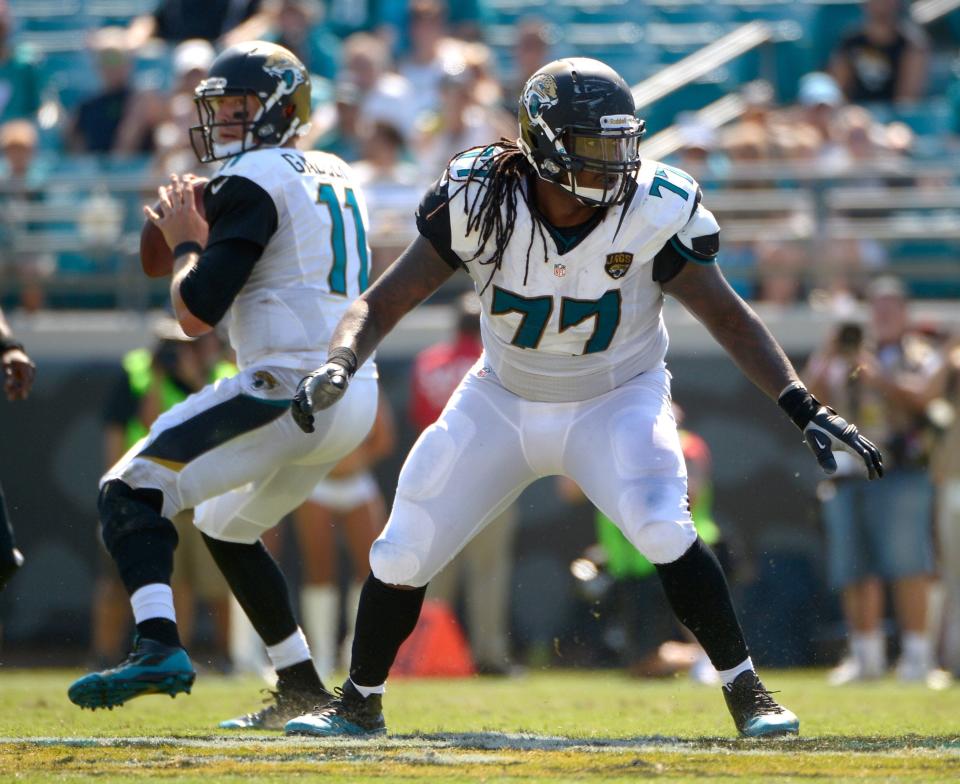 FILE - In this Sept. 8, 2013 file photo, Jacksonville Jaguars guard Uche Nwaneri (77) blocks as quarterback Blaine Gabbert (11) sets up to throw a pass during the second half of an NFL football game against the Kansas City Chiefs in Jacksonville, Fla. The Jaguars have released veteran guard Nwaneri, who started 63 of the team's last 64 games and didn't miss a snap last season. (AP Photo/Phelan M. Ebenhack, File)