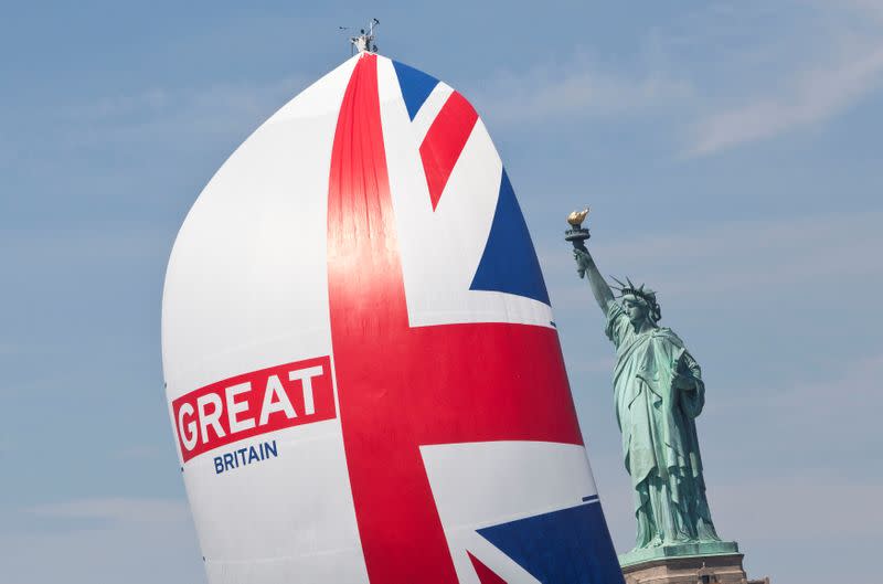 FILE PHOTO: A yacht from the Clipper Round The World race sails past the Statue of Liberty during a ceremonial parade in the Hudson River, New York.