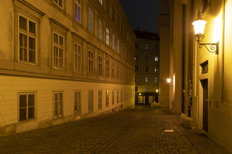 Empty streets on the evening before the beginning of a nationwide lockdown due to the fast rising COVID-19 infections in the country in Vienna, Austria, Sunday, Nov. 21, 2021. (AP Photo/Lisa Leutner)