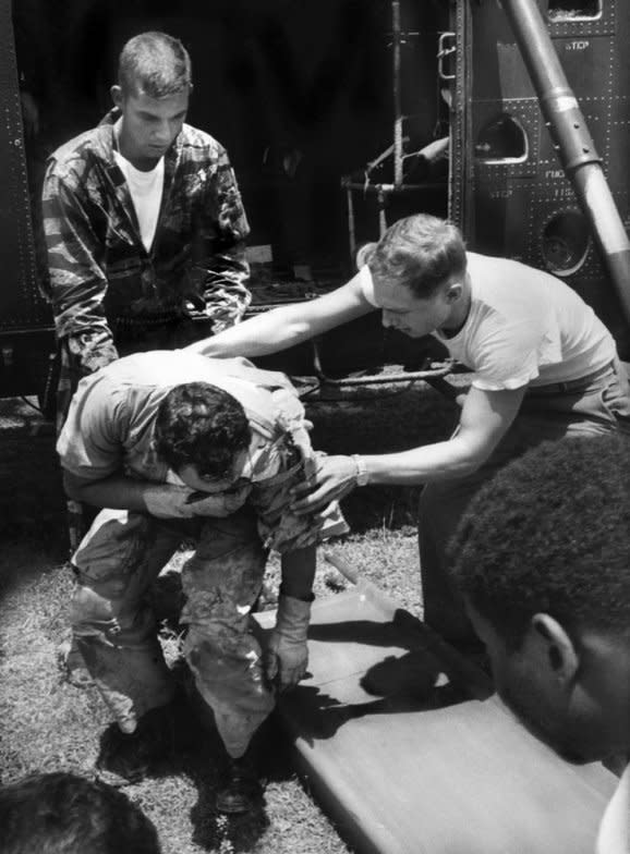 Back at Da Nang, wounded Sergeant Owens is eased out of the copter by Farley and a fellow Marine. (Larry Burrows—Time & Life Pictures/Getty Images) <br> <br> <a href="http://life.time.com/history/vietnam-war-one-ride-with-yankee-papa-13/#1" rel="nofollow noopener" target="_blank" data-ylk="slk:Click here to see the full collection at LIFE.com;elm:context_link;itc:0;sec:content-canvas" class="link ">Click here to see the full collection at LIFE.com</a>