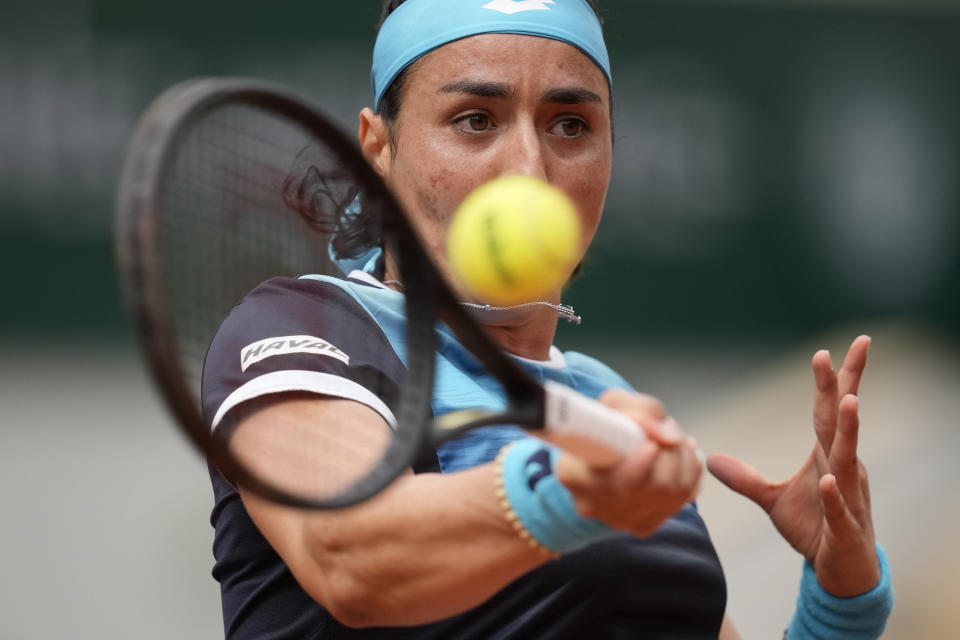Tunisia's Ons Jabeur plays a shot against Poland's Magda Linette during their first round match at the French Open tennis tournament in Roland Garros stadium in Paris, France, Sunday, May 22, 2022. (AP Photo/Christophe Ena)