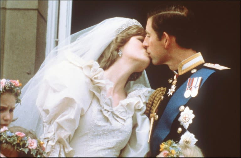 Prince Charles and his new wife, Lady Diana, kiss on the balcony of Buckingham Palace before a huge crowd in 1981