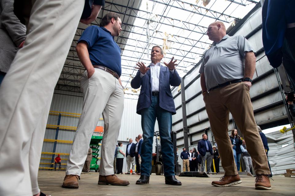 Governor Bill Lee speaks to H.T. Hackney employees Breanna Walker, human resources, John Barry, general manager, and Jason Hughey, sale manager, while surveying the damage to a warehouse at The H.T. Hackney Co. Covington Division in Covington, Tenn., on Friday, April 28, 2023. Lee visited Covington to learn how the community and businesses are recovering after an EF-3 tornado hit the area on March 31. 