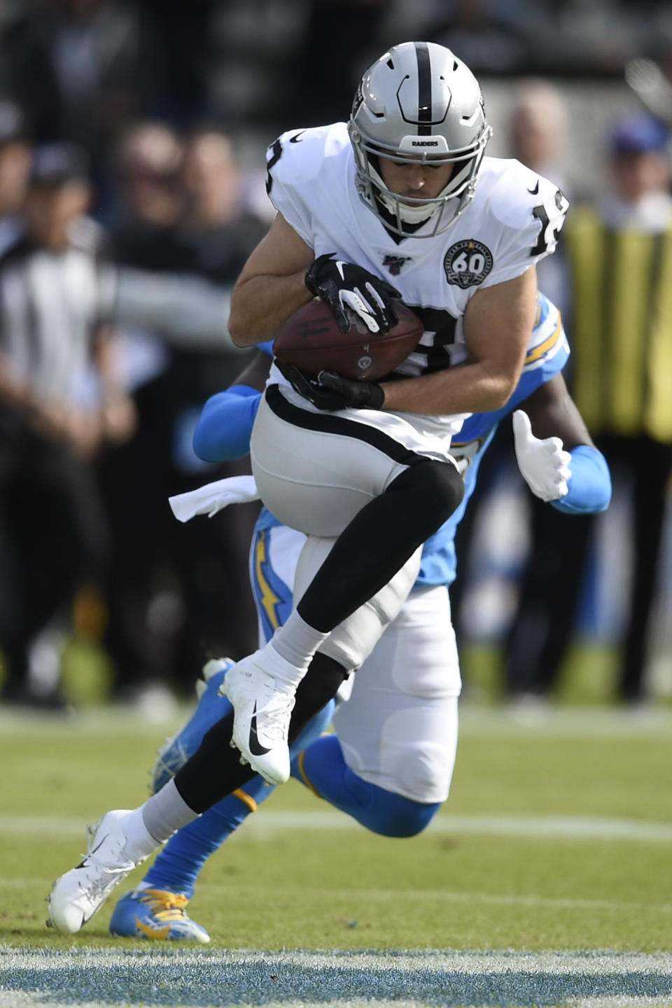 Oakland Raiders wide receiver Hunter Renfrow catches a touchdown pass in front of Los Angeles Chargers defensive back Desmond King during the first half of an NFL football game Sunday, Dec. 22, 2019, in Carson, Calif. (AP Photo/Kelvin Kuo)