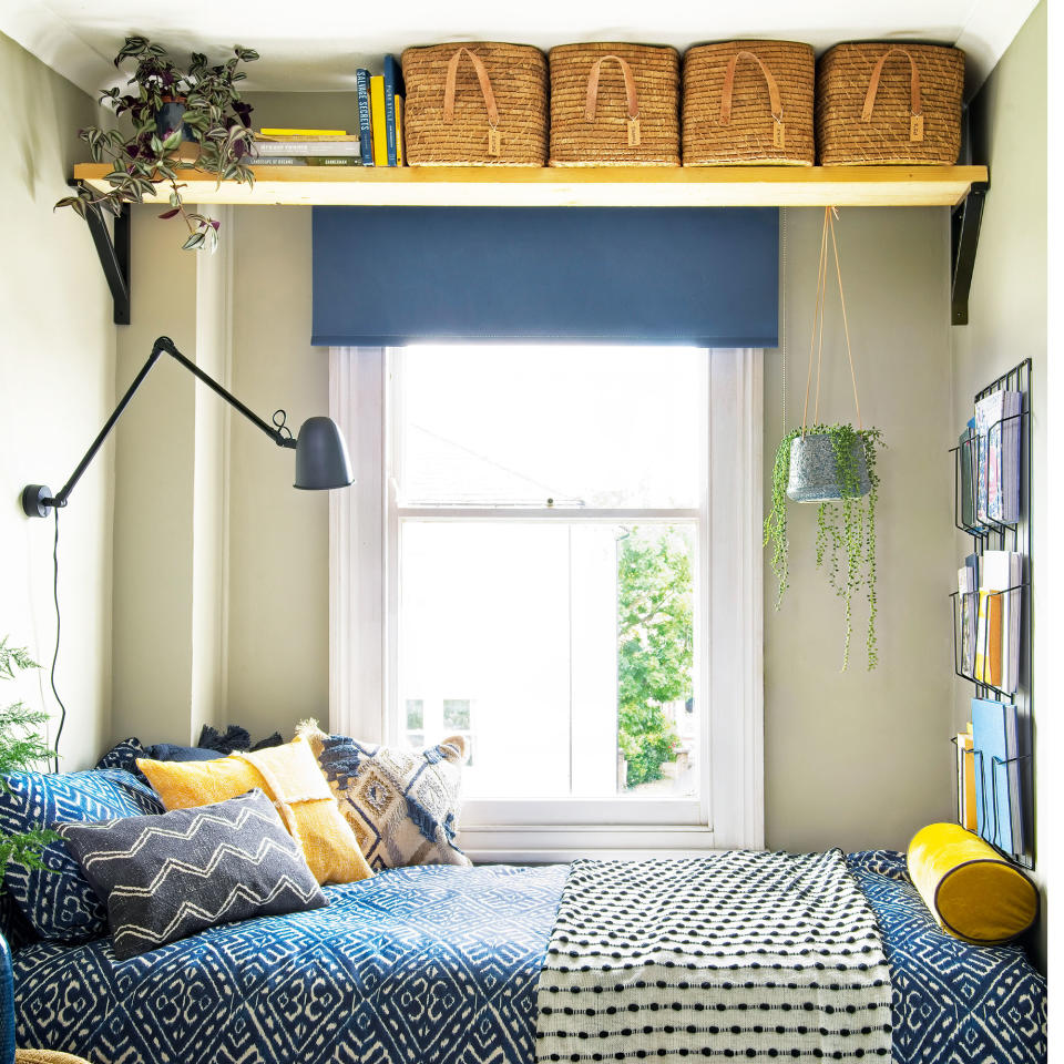 Small bedroom with cabin bed, wall lighting and overhead storage