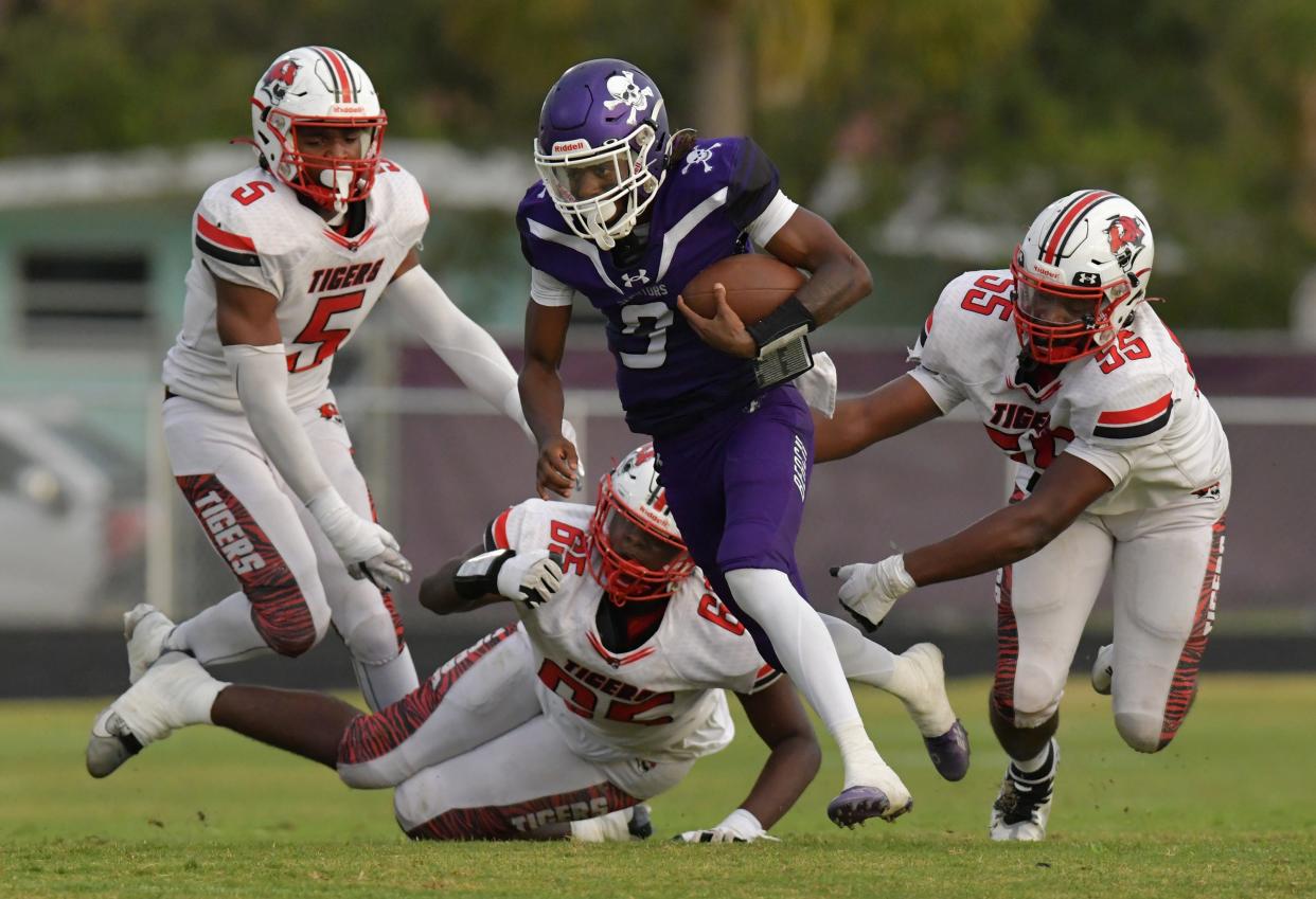 Fletcher's Cron Davis (9) gets away from Andrew Jackson Tigers defenders during a second quarter run. The Jackson H.S. Tigers traveled to Fletcher High School's Jack Taylor Stadium in Neptune Beach for High School football Friday, September 8, 2023.