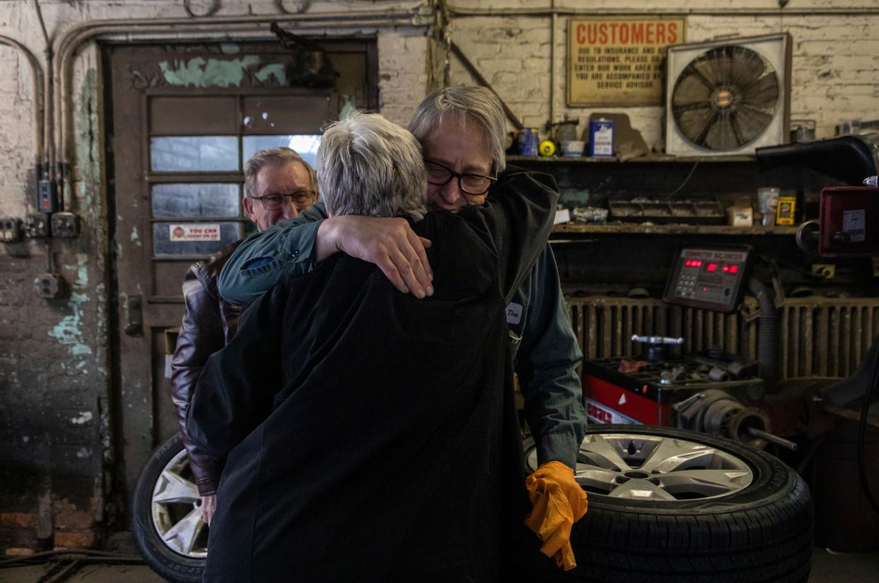 Mike Warholak Jr. hugs Patty Reid, a customer of over 30 years, during the last day of ownership by the Warholak family inside Warholak Tire Service in Detroit on Tuesday, Oct. 31, 2023.