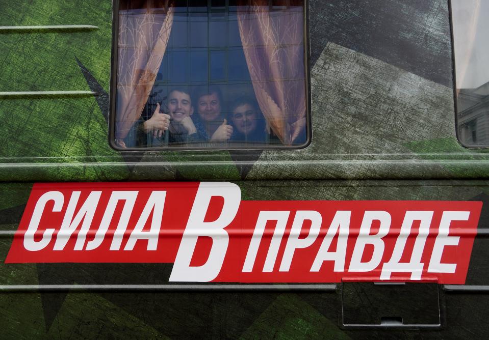 People look through a window of a Russian Defense Ministry train with the words "Strength in Truth" emblazoned on it in Rostov-on-Don, Russia, Sunday, March 3, 2024. (AP Photo)