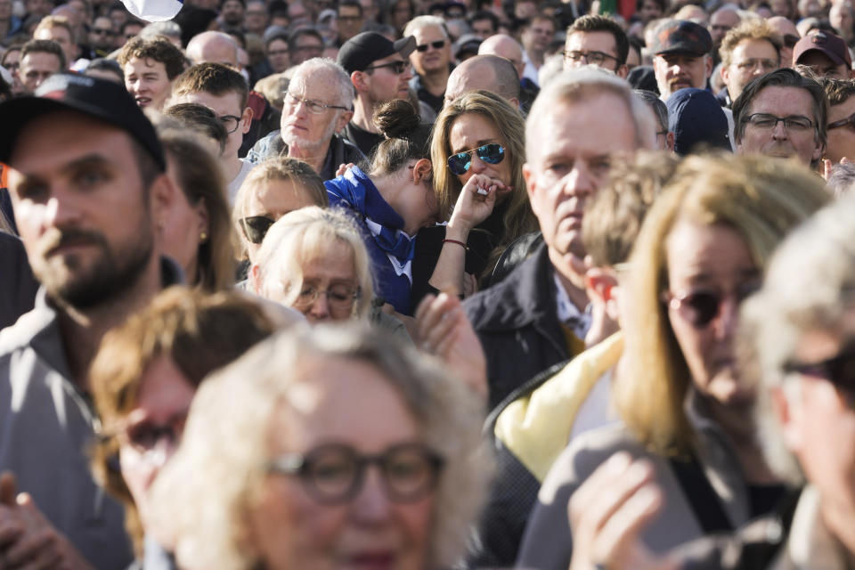 Two women react emotionally during a speech at a demonstration against antisemitism and to show solidarity with Israel in Berlin, Germany, Sunday, Oct. 22, 2023. (AP Photo/Markus Schreiber)