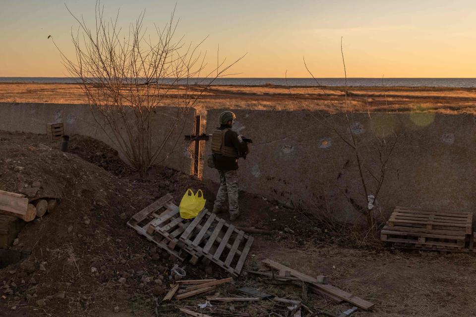 A Ukrainian serviceman of the 123rd Territorial Defense Brigade stands guard on a position next to the Dnipro River (AFP via Getty Images)