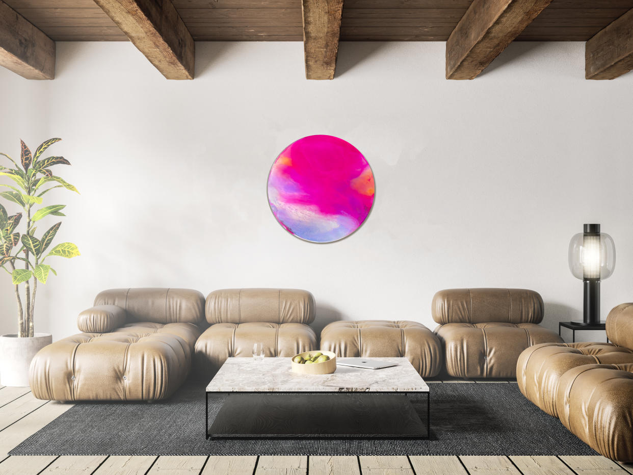  A living room featuring a large circular resin mirror. 