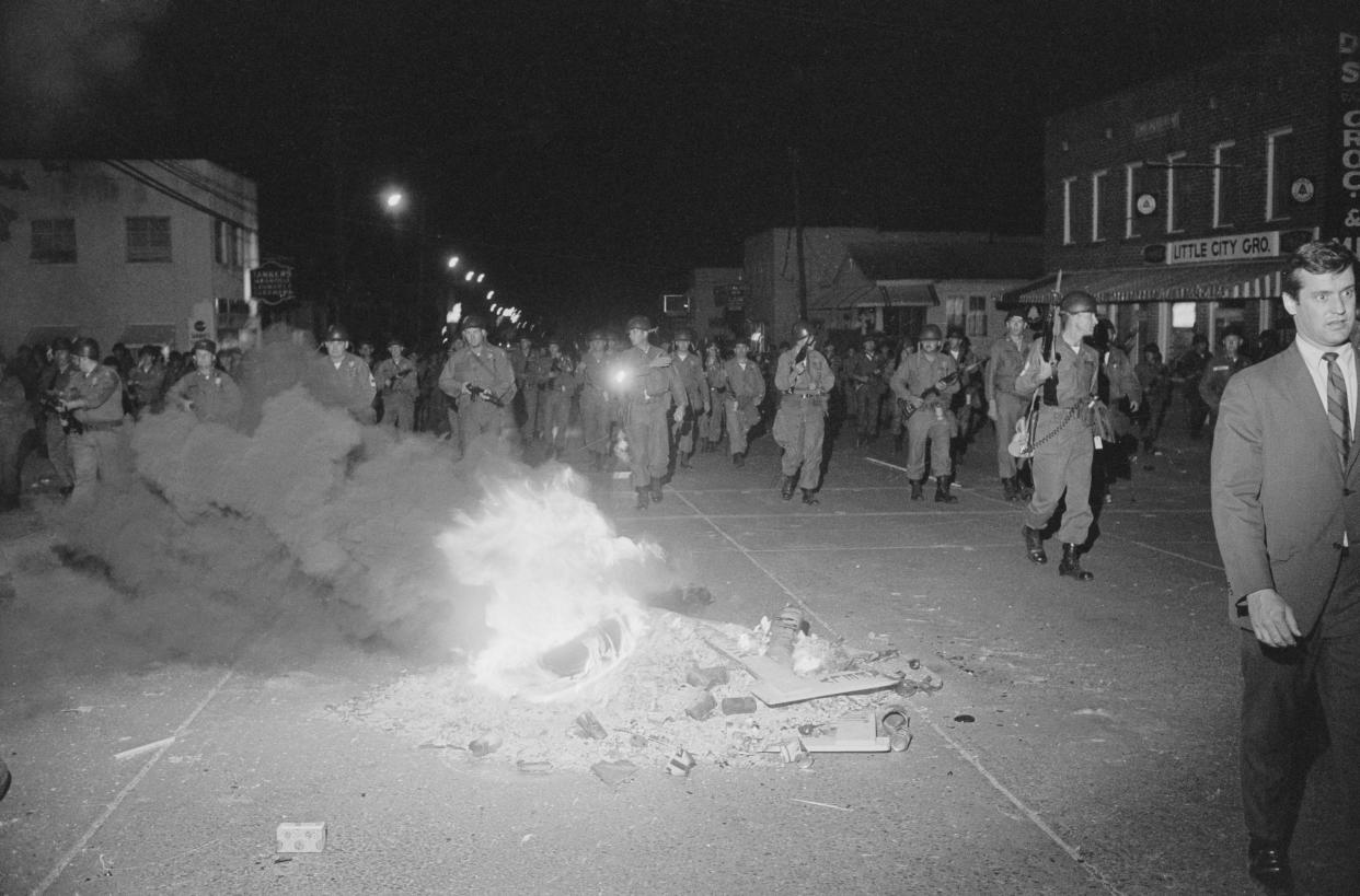 Hundreds of National Guardsmen patrol a riot-torn street near Jackson State College in Jackson, Miss.