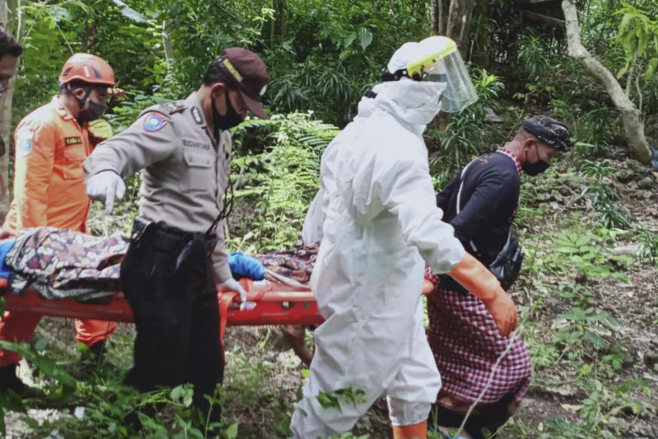 In this photo released by Indonesian National Search And Rescue Agency (BASARNAS), rescuers carry Ukrainian man Roberts Jacob Matthews on stretcher in Pecatu, Bali, Indonesia, on June 6, 2020. Matthews, who fell into an abandoned well and broke his leg while being chased by a wild dog on Indonesia’s tourist island of Bali, was rescued after being trapped for nearly a week, police said Monday, June 8, 2020. (BASARNAS via AP)
