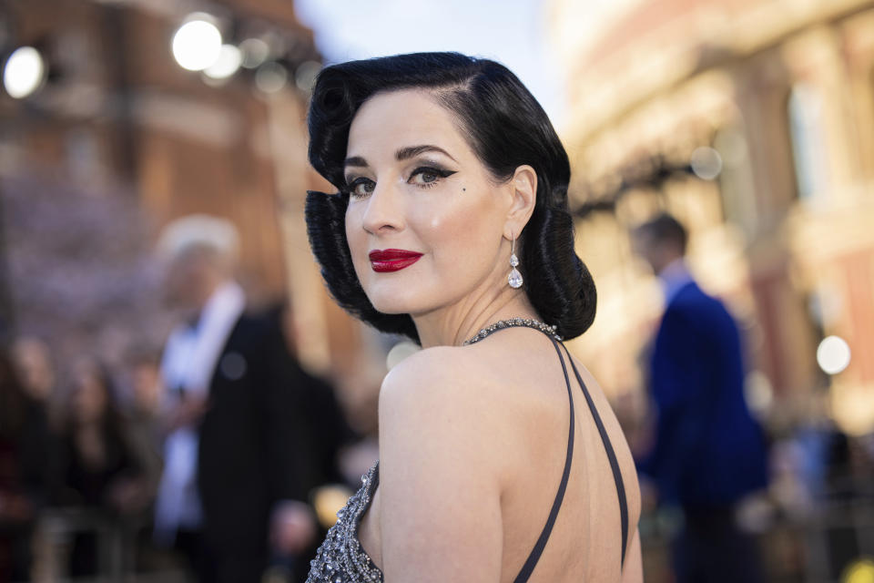 Dita Von Teese poses for photographers upon arrival at the Olivier Awards in London, Sunday, April 2, 2023. (Photo by Vianney Le Caer/Invision/AP)