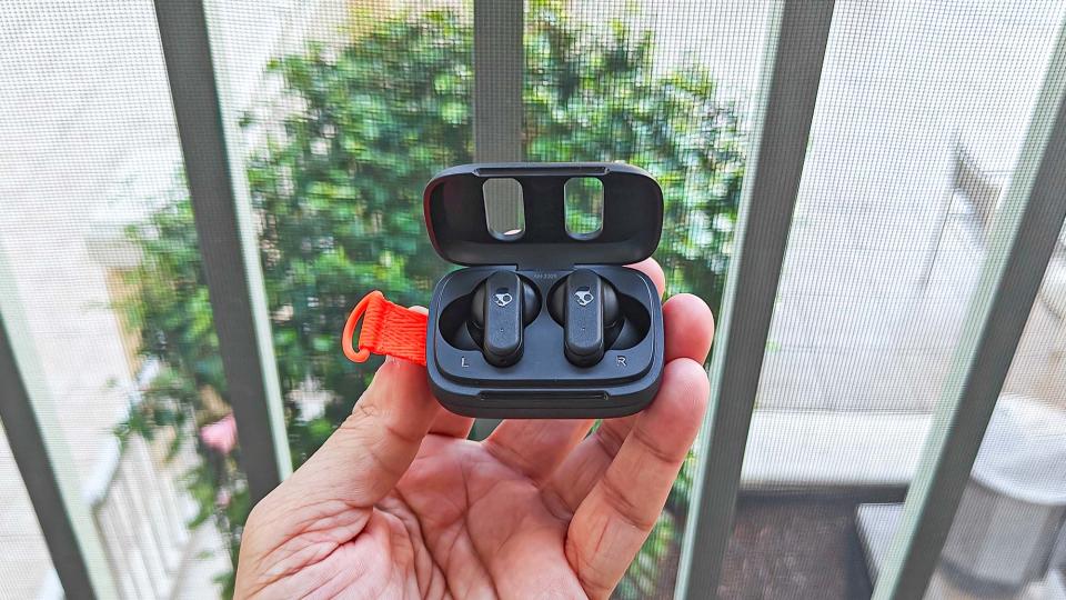 Skullcandy Dime 3 in charging case held in hand