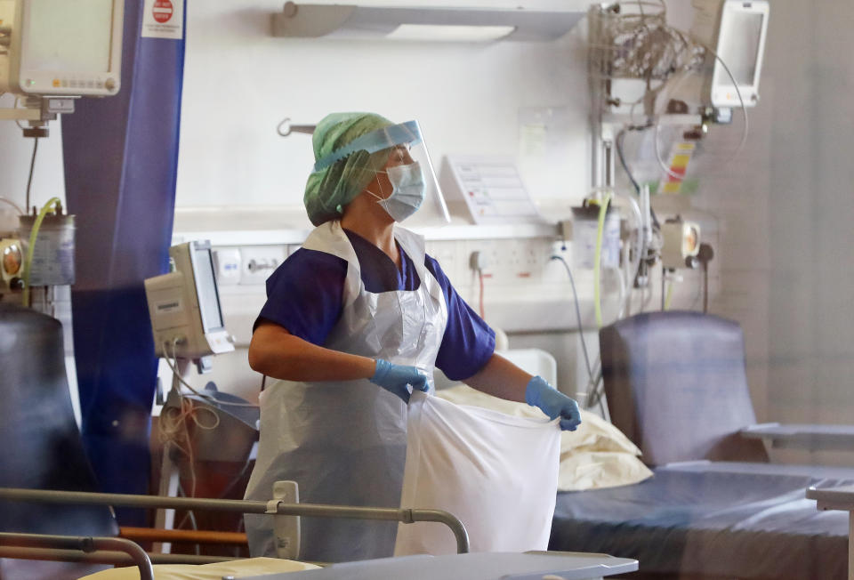 A nurse changes bed clothes at the Mater Hospital Covid-19 recovery ward in Belfast. (Photo by Niall Carson/PA Images via Getty Images)