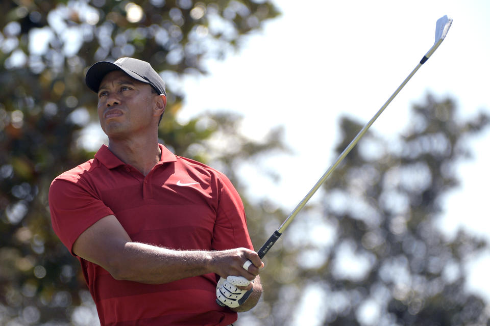 Tiger Woods watches his tee shot on the second hole during the final round of the Arnold Palmer Invitational golf tournament. (AP)