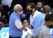 North Carolina head coach Roy Williams bumps-fists and talks with UNLV head coach T.J. Otzelberger after an NCAA college basketball game in the Maui Invitational tournament, Monday, Nov. 30, 2020, in Asheville, N.C. (AP Photo/Kathy Kmonicek)