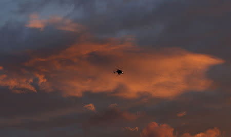 A search helicopter flies near the Clinton Correctional Facility in Dannemora, New York, June 8, 2015. REUTERS/Chris Wattie